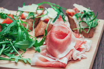 Delicious meal with prosciutto and arugula