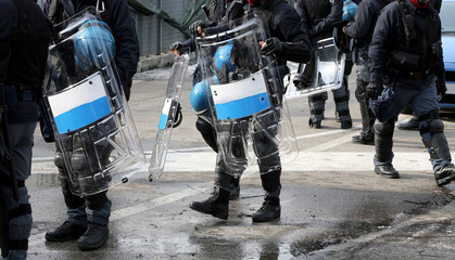 policemen with shields and riot gear during the sporting event i