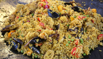 Spanish paella with yellow rice and mussels and seafood