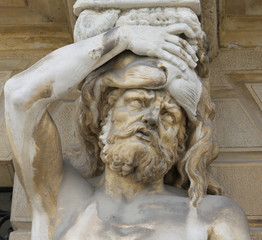statue called caryatids with her hand on her forehead and it see