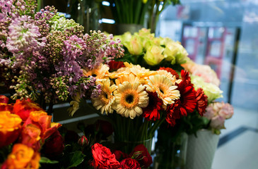 Colorful roses and other flowers at the entry to flower shop,Bouquet decorate in front of flower shop,Many flowers in the market,flowers at farmers' market