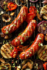 Grilled sausages and vegetables with addition spices and fresh herbs