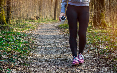Sporty woman walking in the forest