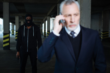 Serious male kidnapper wearing a mask