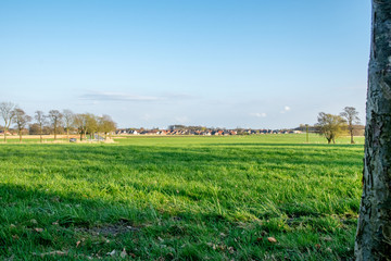 Fototapeta premium German Village behinde a green field