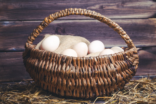 Eggs in basket vintage background.