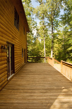 Exterior of a Log House with a Wooden Deck