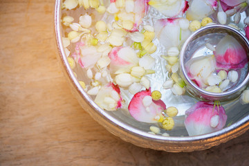 Jasmine and roses flower in water bowl, Songkran festival background in Thailand