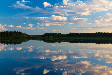 Cloudy sky reflected in the smooth surface of the river