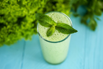 healthy food concept. milkshake in glass and fresh green vegetables. detox diet