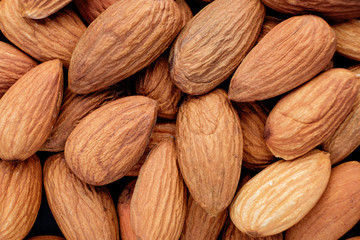 handful of almonds close up food background top view