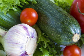 fresh vegetables: garlic, lettuce, tomato, cucumber, onion, zucchini and cherry tomatoes