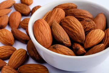 almonds on white plate macro on nuts background
