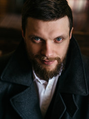 Fototapeta premium Young bearded man in a pub, vintage style