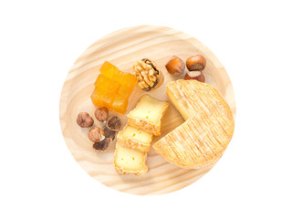 Cheese, hazelnuts, walnut and marmalade on the wooden board top view