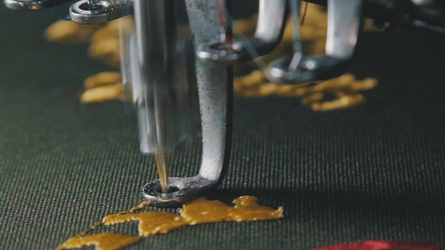 Textile - Professional and industrial embroidery machine. Machine embroidery is an embroidery process whereby a sewing machine or embroidery machine is used to create patterns on textiles.