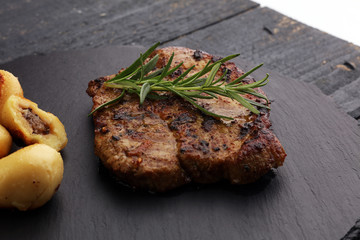 Grilled steaks, baked potatoes and salad