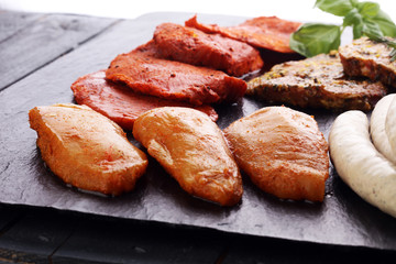 Selection of marinaded meat for grilling and sausages
