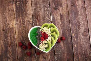 Obraz na płótnie Canvas breakfast smoothie bowl with raspberries, kiwi and chia - diet concept