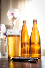 beer bottles and a glass on a table
