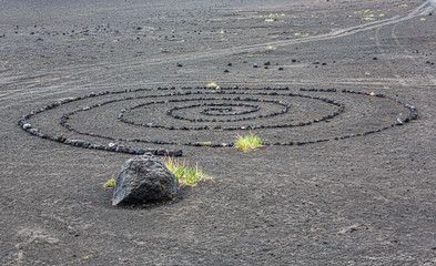 Cryptic spiral lined with stones on a lifeless volcanic plateau Plosky Tolbachik - Kamchatka, Russia
