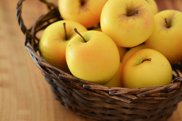 Closeup of a basket of golden apples