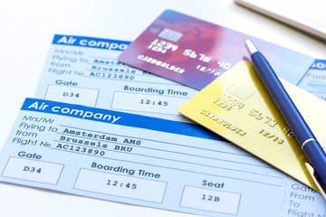 Credit cards with airline tickets for vacations on table background