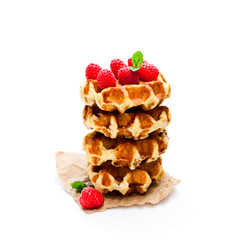 Continental  classics belgian butter waffles with raspberries isolated on white