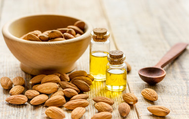 cosmetic set with almond oil on wooden table background