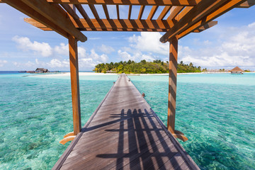 Wooden path leading to Moofushi atoll's paradise, Maldives, Indian Ocean.
