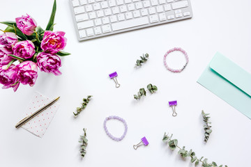 Trendy design of workdesk with blossom on white background top view