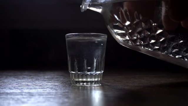 Poured a glass of vodka, close-up .