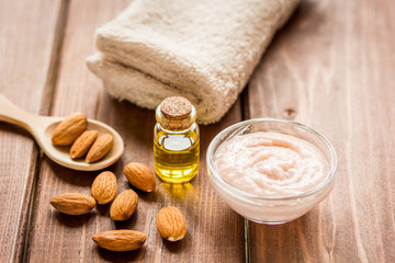 Obraz na płótnie Canvas cosmetic set with almond scrub on table background