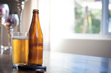 beer bottles and a glass on a table