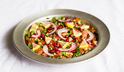 Tabbouleh salad against white background. Selective focus.
