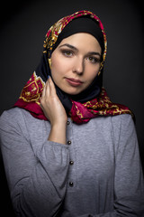 Fashion model wearing hijab for conservative modern clothing mostly associated with muslims, middle...