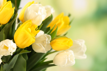 Beautiful bouquet of white and yellow tulips on blurred background