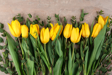 Beautiful yellow tulips on light background