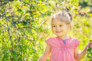 Happy little girl playing in sunny park