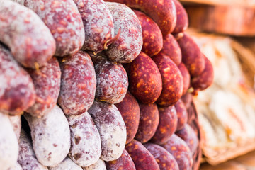 Selection of traditional Italian cured meats and sausages at a street food market, selective focus © Aleksandr Vorobev