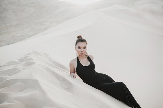 Young beautiful sexy asian model is posing in desert