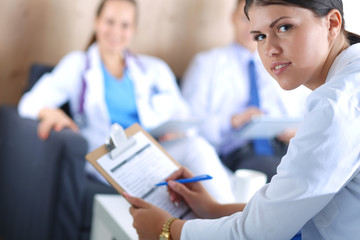Fototapeta premium Two young women doctors sitting on the sofa