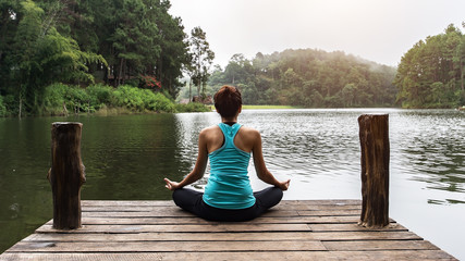 Close up hand. Woman do yoga outdoor. Woman exercising yoga at the nature background, select focus