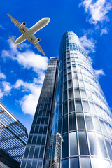 Fototapeta na wymiar airplane with modern building. Jet over City