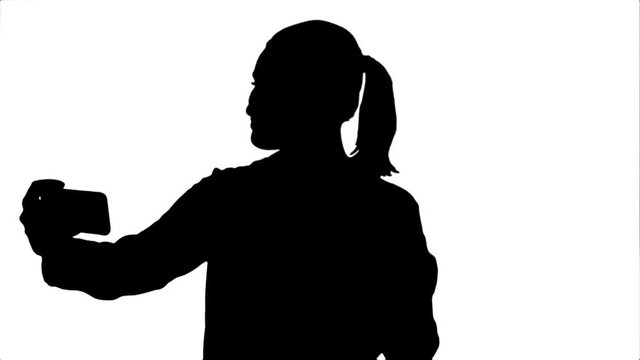 Silhouette Businesswoman taking funny selfie with phone.