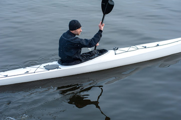 Kayaking on the river in the city near the shore 04