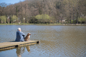 Man with dog on landing stage