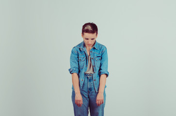Gave up, defeated. Portrait half body sad insecure teenager hands head down isolated grey green...