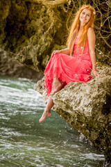 outdoor portrait of young happy smiling woman on natural tropical background