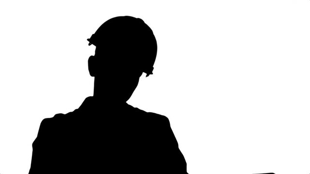 Silhouette Stressed female engineer in helmet checking constraction plan.